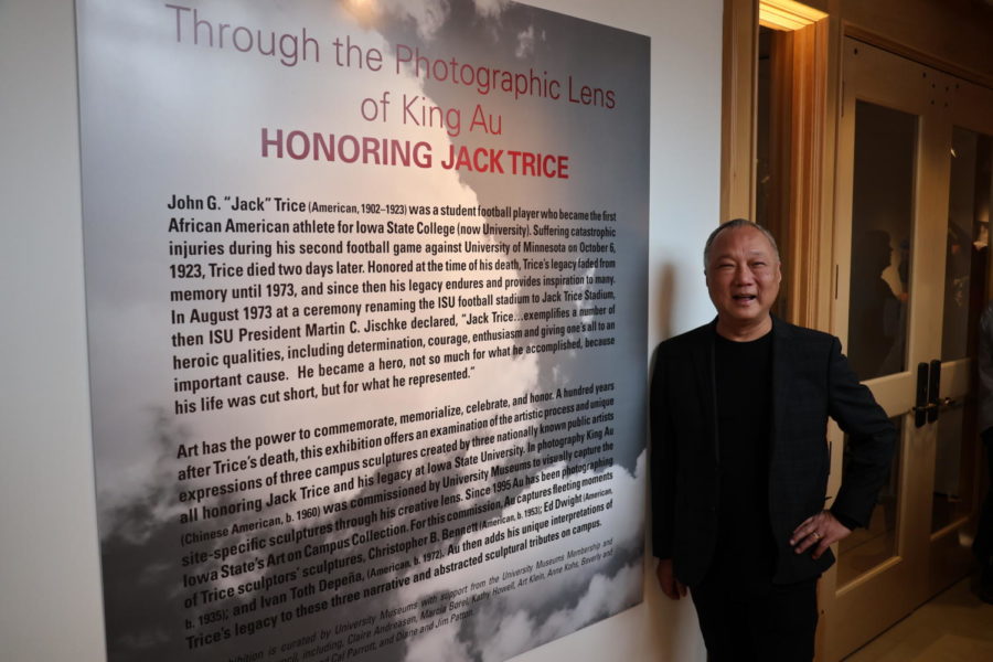 Artist King Au stands next to a display about Jack Trice at the Neva M. Petersen Maquette Gallery in Morill Hall on Jan. 21, 2023.
