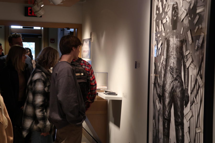 Visitors view the Game Day exhibit at the Through the Photographic Lens of King Au: Honoring Jack Trice exhibit at the Neva M. Peterson Maquette Gallery at Morill Hall on Jan. 21, 2023. 