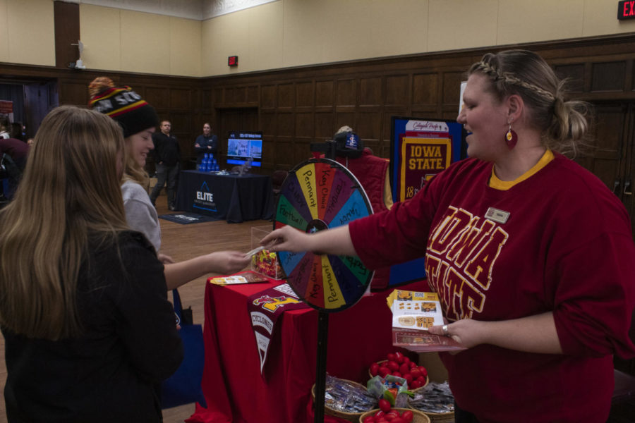 ISU Bookstore representative Valerie Willcox hands out flyers at WelcomeFest, Jan. 31. 
