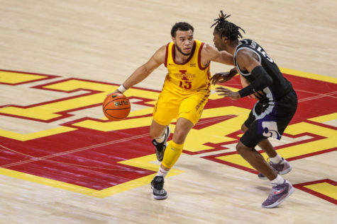 Jaren Holmes brings the ball up the floor against K-State on Jan. 24, 2023.