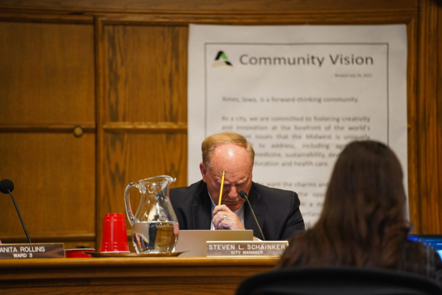 Ames City Council member Steven Schainker listens to a concerned citizen on Jan. 24. 
