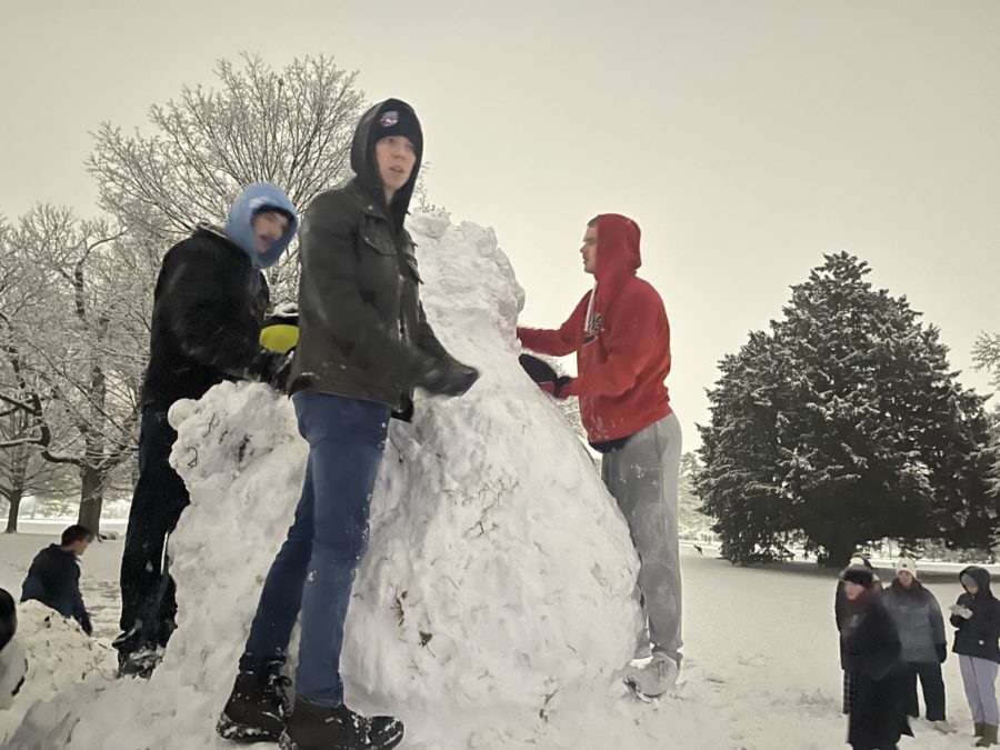 Students build a giant snowman on central campus on Jan. 18, 2023.