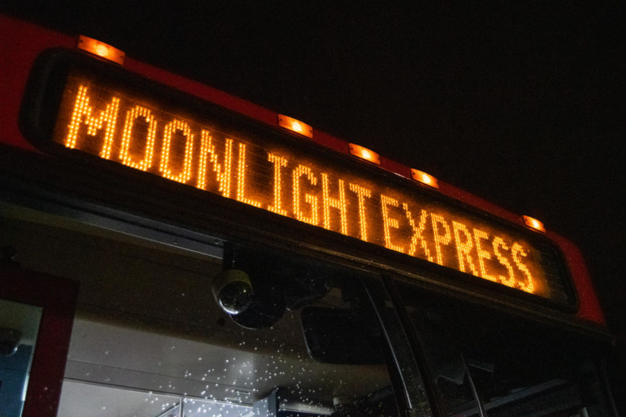 The sign of a CyRide bus shines the words Moonlight Express while parked at the Ames Middle School.