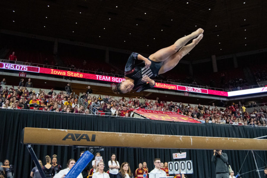 Hannah Loyim flips off of the beam during the match against Central Michigan in Hilton Coliseum on Feb. 12, 2023.