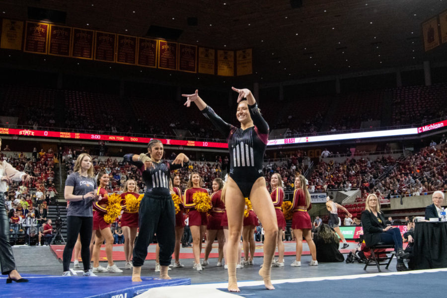 Laura Cooke strikes a pose in her floor routine during the match against Central Michigan in Hilton Coliseum on Feb. 12, 2023.