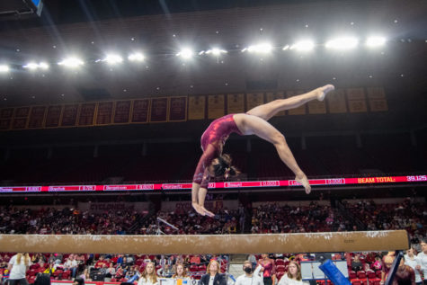 Loganne Basuel performs a backflip in her beam routine during the meet against Denver University in Hilton Coliseum on Feb. 24, 2023.
