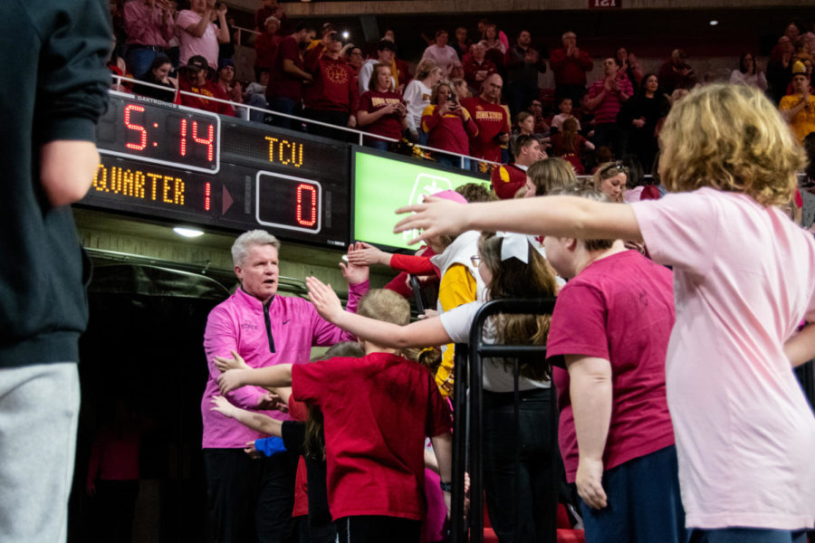Head+Coach+Bill+Fennelly+high-fives+fans+while+walking+out+onto+the+court+before+the+game+against+TCU+in+Hilton+Coliseum+on+Feb.+25%2C+2023.