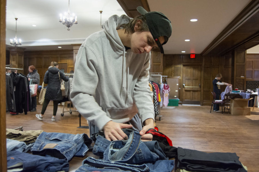 Patrick Kinn looks for jeans in his size at the clothing swap at the Sustainapalooza on Feb. 21, 2023.