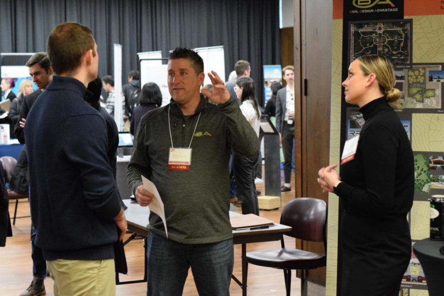 Cole Knudsen, a senior majoring in landscape architecture, pictured talking with representatives of Civil Design Advantage, a consulting firm specializing in civil engineering, landscape architecture, land planning and surveying, according to its CyHire page.