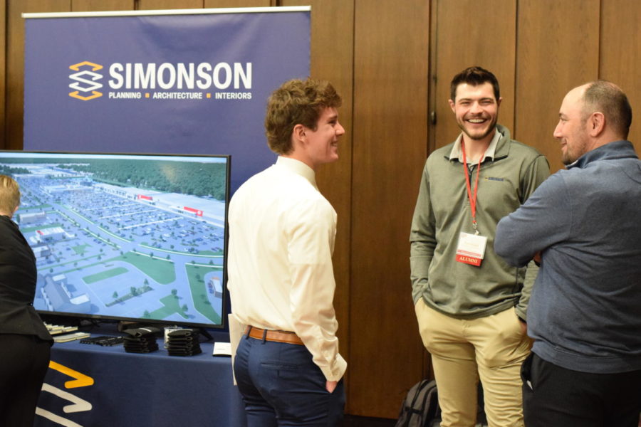 Nathaniel (Nate) Stoltenberg, a senior majoring in architecture, pictured talking with representatives from Simonson and Associates L.L.C., an architectural and landscape architecture planning firm.
