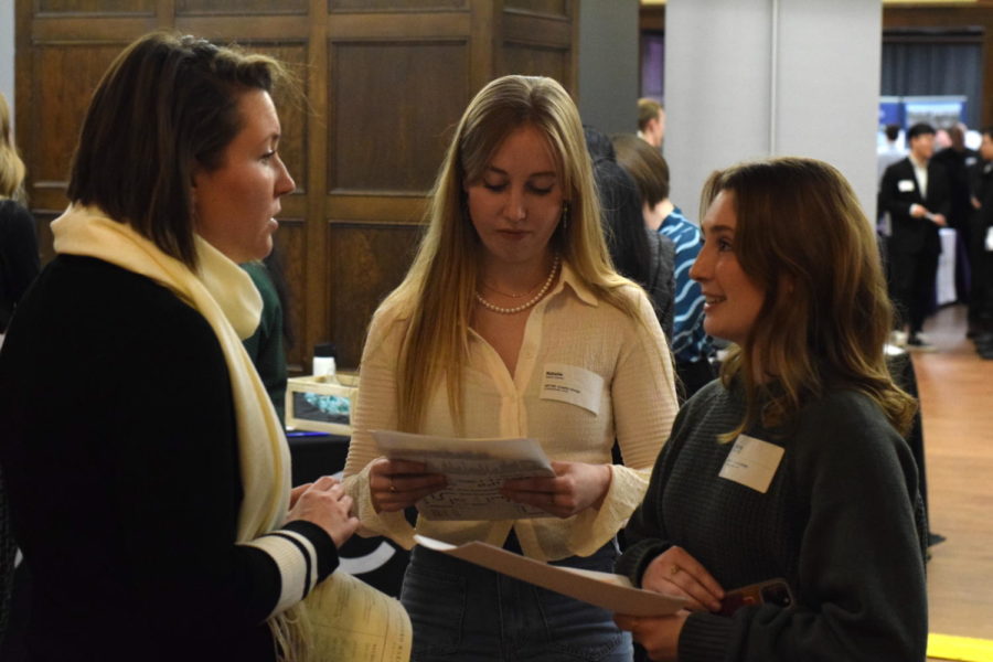 Natalie Clement (center) and Sierra Kruger (right), both juniors in graphic design, pictured talking with a representative of Merrill Manufacturing. Clement said while most employers at the fair wait for students to approach them, the Merrill Manufacturing representative approached them for a conversation while they were waiting near another booth.