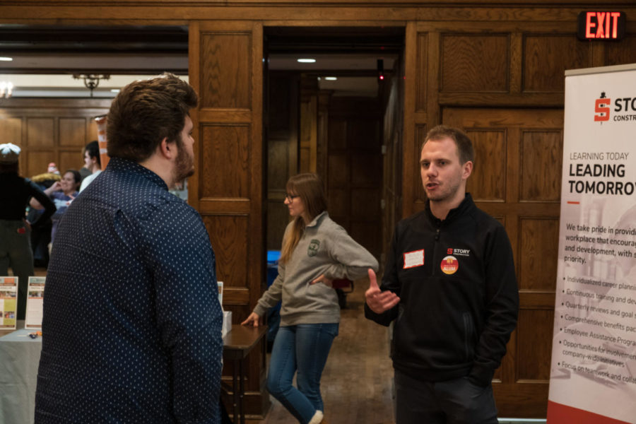 Due to inclimate weather, some businesses cancelled their appearance at the People to People Career Fair. Pictured is a representative of Story Construction talking with a student in Memorial Unions Great Hall.