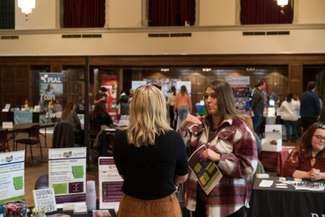 A representative of Autumns Center talking with a student at the spring 2023 People to People Career Fair in the Memorial Union. 