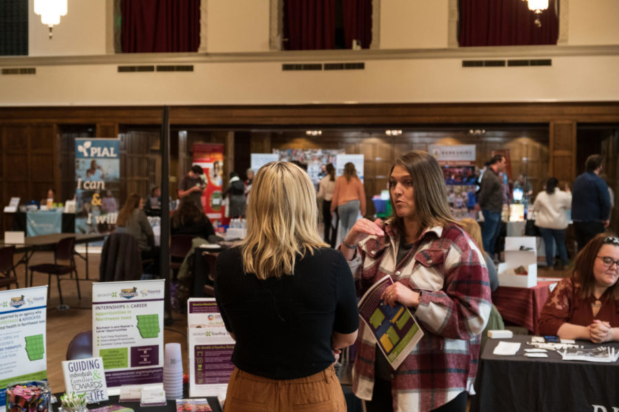 A representative of Autumns Center talking with a student at the spring 2023 People to People Career Fair in the Memorial Union. 