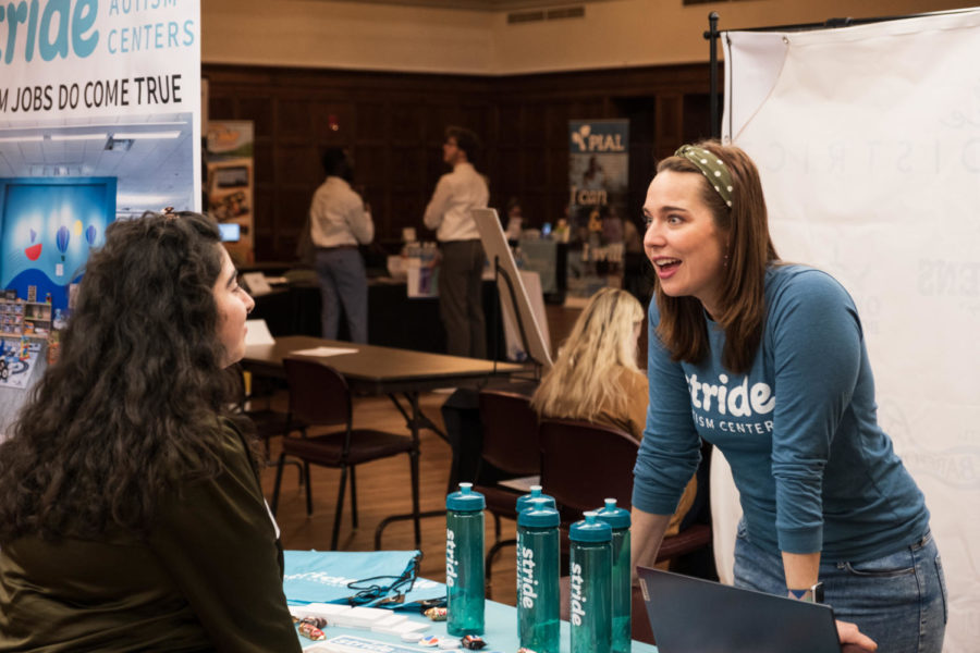 A representative of Stride Autism Centers talking with a student at People to People Career Fair in Memorial Union. 