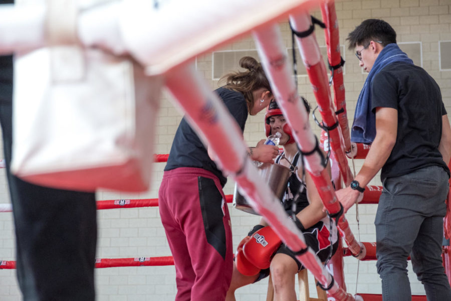 Iowa State student Izzat Azmi in the red corner getting advice from coach Liv Meyer.