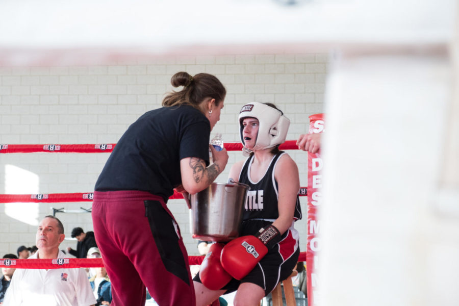 Iowa State junior Ella Kannegiesser in the red corner getting advice from coach Liv Meyer. Kannegiesser competes on a national level and received an All American title last year. She is also the vice president of the ISU Boxing Club. 