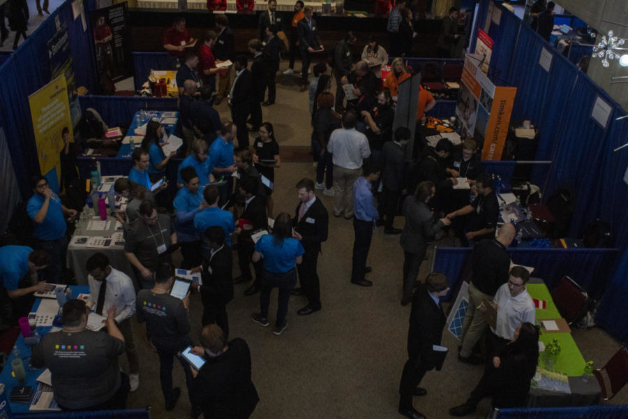 Students captured are gathered on the first floor of the Scheiman building to inspect multiple company booths. 