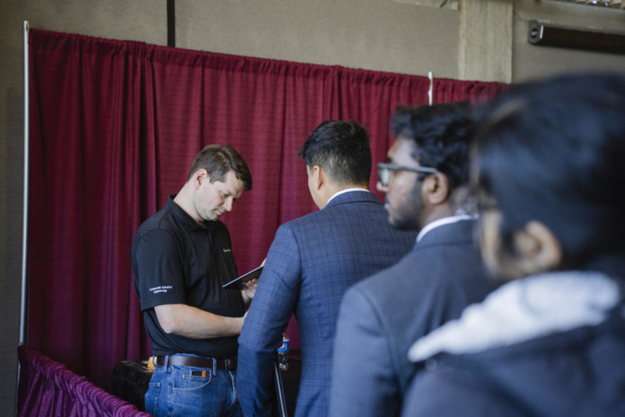A representative of the Collins Aerospace corporation meets with students at the Spring Engineering Career Fair on Feb. 7. 