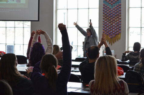 Sue Tew-Warming, President of Heartland Wellbeing Institute, practices mindful movement with participants of the Mindfulness at Work breakout room in the Campanile Room of the Memorial Union on Feb. 3. 