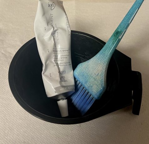 A brush, gloves and mixing bowl are essential for at home hair dyeing.