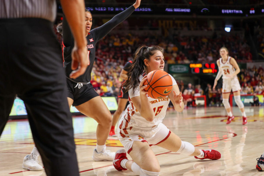 Izzi Zingaro falls under the basket , trying to find available teammate to pass to against Texas Tech on March 4, 2023.
