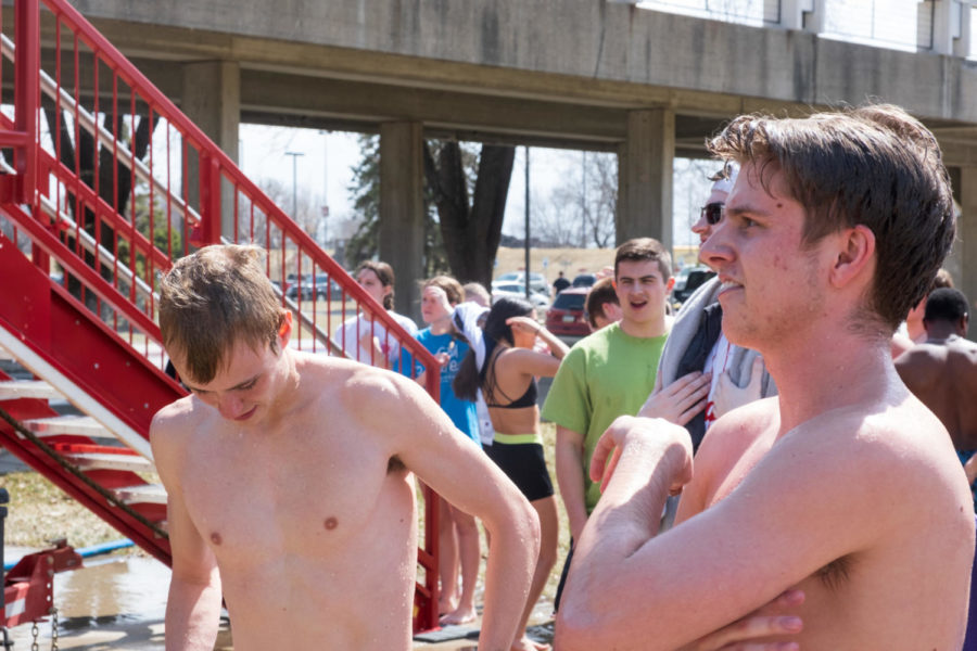 Hayden Moore, a freshman in finance, and Luke Post, a sophomore in electrical engineering, waiting in line to plunge into the water. 