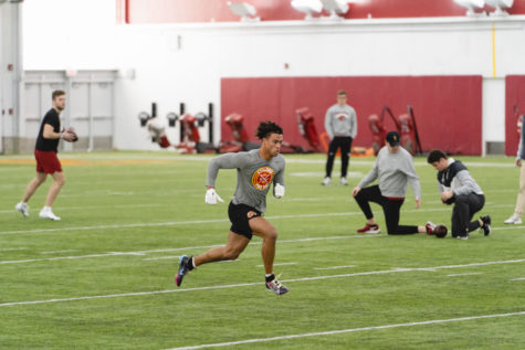 Xavier Hutchinson runs routes, catching balls from Hunter Dekkers at pro day, Bergstrom Football Complex, Mar. 21, 2023. 