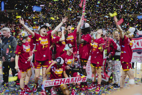 The Iowa State womens basketball team celebrates on stage after ISUs Big 12 Championship win over Texas, 61-51. Municipal Auditorium in Kansas City, MO, Mar. 12, 2023.