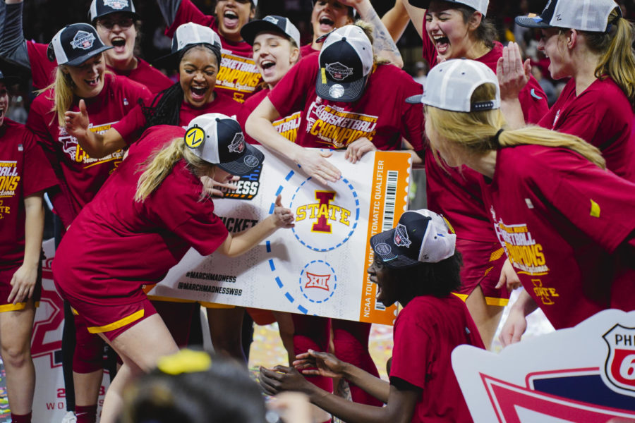 The+Iowa+State+womens+basketball+team+places+its+university+logo+on+to+their+ticket+punched+March+Madness+sign+The+Iowa+State+womens+basketball+team+celebrates+on+stage+after+ISUs+Big+12+Championship+win+over+Texas%2C+61-51.+Municipal+Auditorium+in+Kansas+City%2C+MO%2C+Mar.+12%2C+2023.
