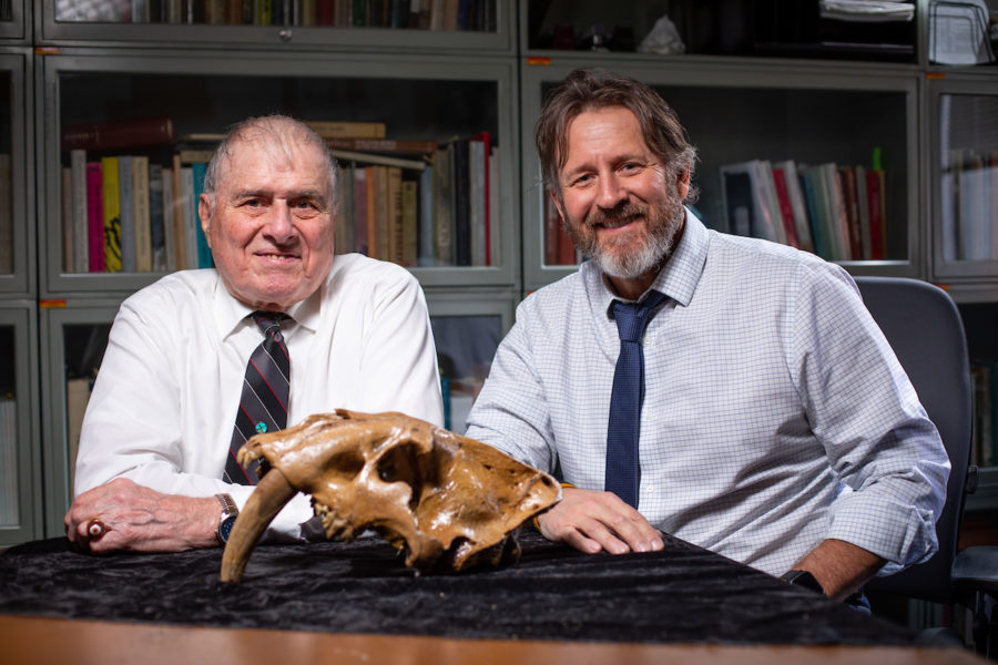 David Easterla, left, and Matthew Hill, right, with a near-complete skull of a saber-toothed cat found in southwest Iowa.