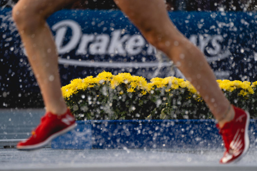 Participants in the collegiate steeplechase run through the water during the 2023 Drake Relays, April 27. 