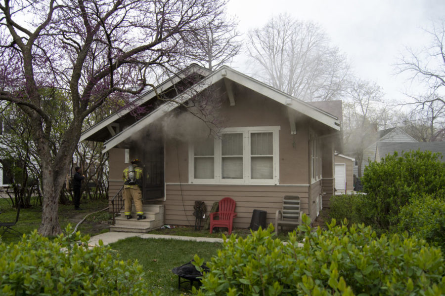 The Ames Fire Department is on the scene as smoke clouds pour out of 702 Ash Ave., Ames, Iowa, on April 21, 2023. The source of the fire is in the basement.