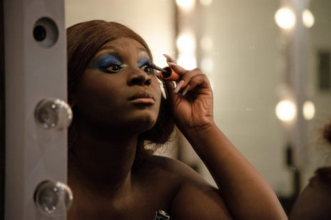Brandie Paye, a model in The Fashion Show: The Suite Escape finishes doing her makeup before the show in C.Y. Stephens Auditorium on April 15, 2023. 