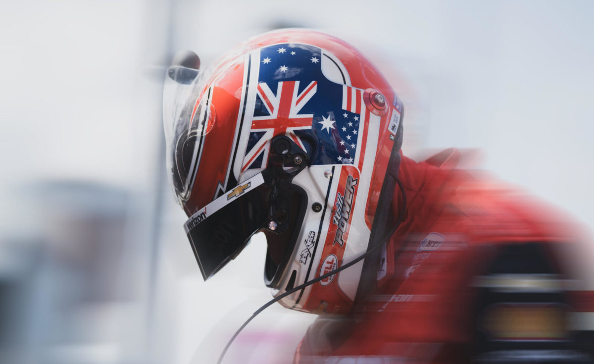 An IndyCar driver looks down through his helmet on Hy-Vee INDYCAR Race Weekend July 21-23, 2023.