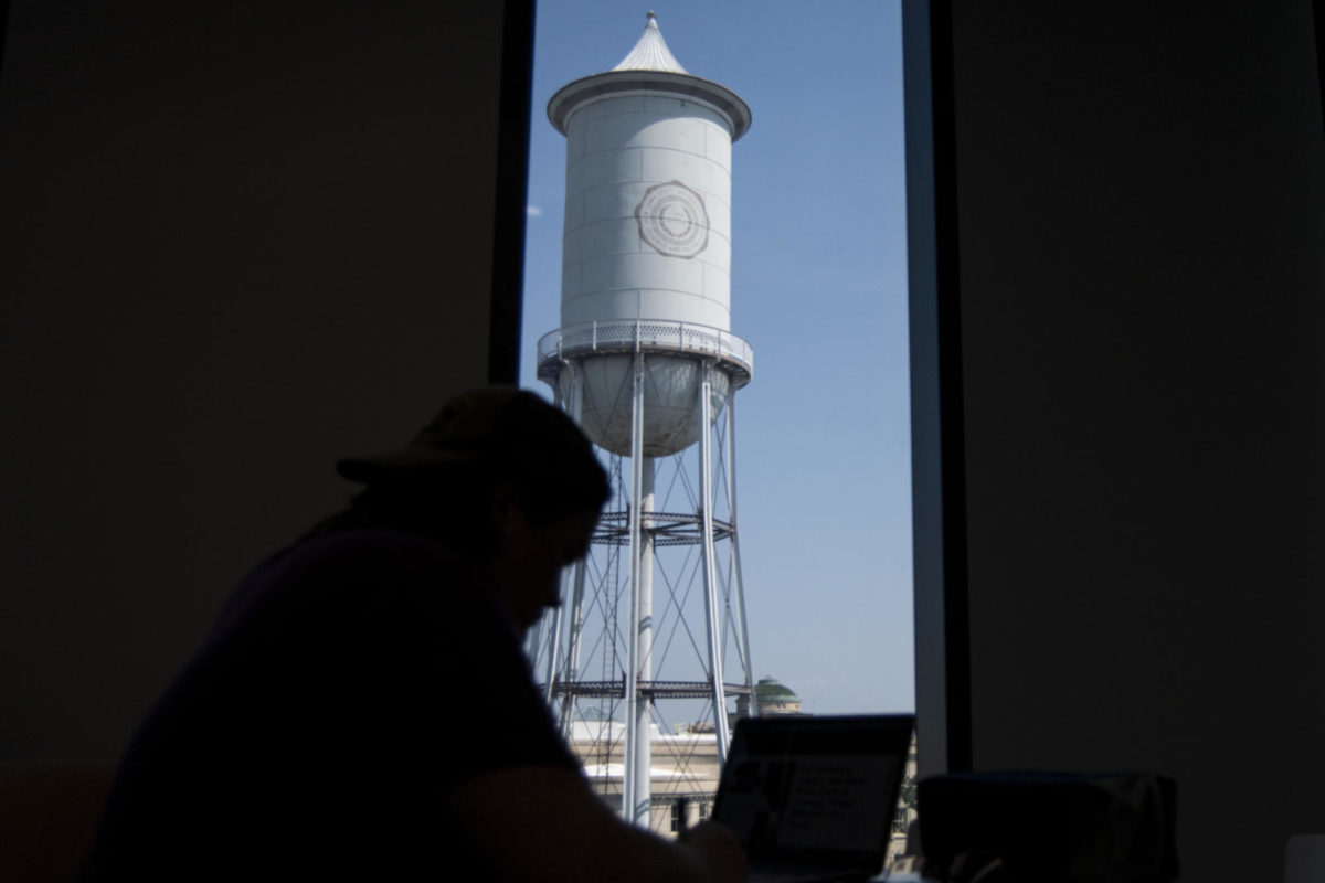 Achilles Seastrom works by a window with a view of the Marston Water Tower on Tuesday, Aug. 29, 2023, at Iowa State’s Student Innovation Center in Ames.