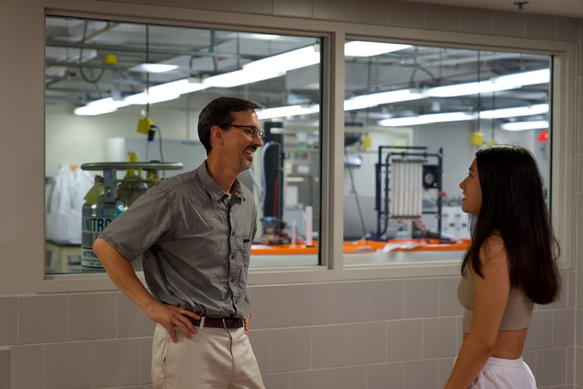 Dr. Ian Schneider discussing lung capacity with freshman Keira Feliciano inside Sweeney Hall on Aug. 23, 2023.