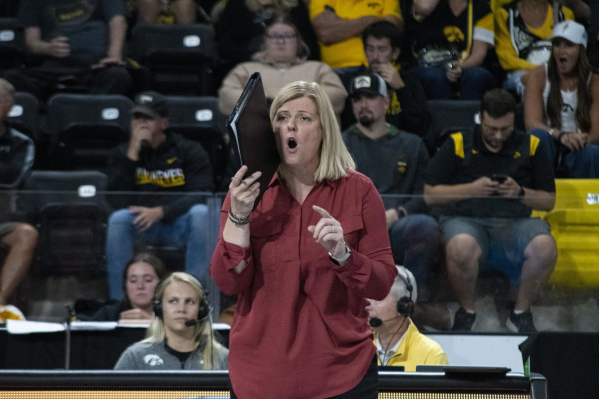 Iowa State’s Head Coach Christy Johnson-Lynch talks to the team behind a folder during the game against Iowa in the Iowa Corn Cy-Hawk Series on Wednesday, Sept. 6, 2023, at the Xtreme Arena in Coralville, Iowa.