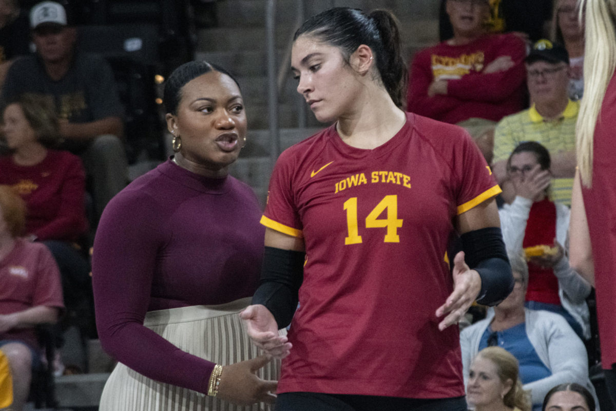 Iowa State’s Assistant Coach Ciara Jones, left, talks to Nayeli Gonzalez, right, during the game against Iowa in the Iowa Corn Cy-Hawk Series on Wednesday, Sept. 6, 2023, at the Xtreme Arena in Coralville, Iowa.