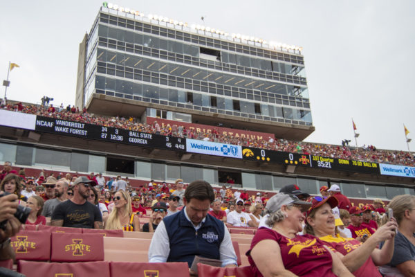 Republican presidential candidate Florida Gov. Ron Desantis sits and reads a program before the Iowa Corn Cy-Hawk Series football game on Saturday, Sept. 9, 2023, at Jack Trice Stadium in Ames.