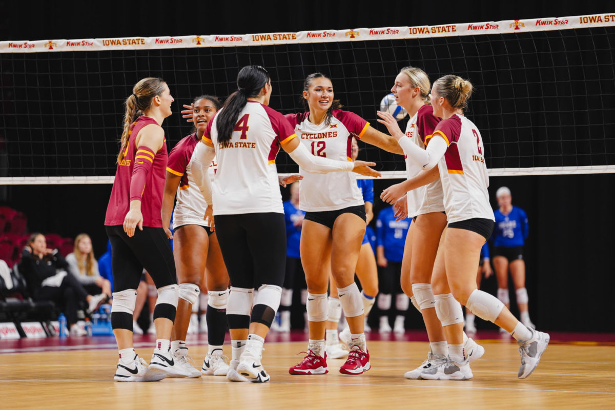 The Iowa State volleyball team huddles together after gaining a point against the Drake Bulldogs at the Cyclone Invitational, Hilton Coliseum, Sept. 16, 2023. 