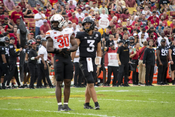 Oklahoma State’s Collin Oliver and Iowa State’s Rocco Becht laugh after a roughing the passer penalty is called on Oliver during the second half of the football game on Saturday, Sept. 23, 2023, at Jack Trice Stadium in Ames.