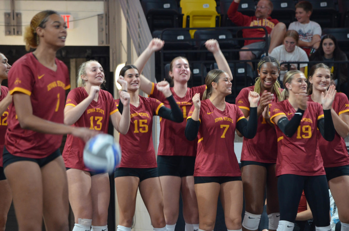 Iowa State University volleyball players cheer for their teammates on the court during the game against the University of Iowa on Wednesday, Sept. 6, 2023.