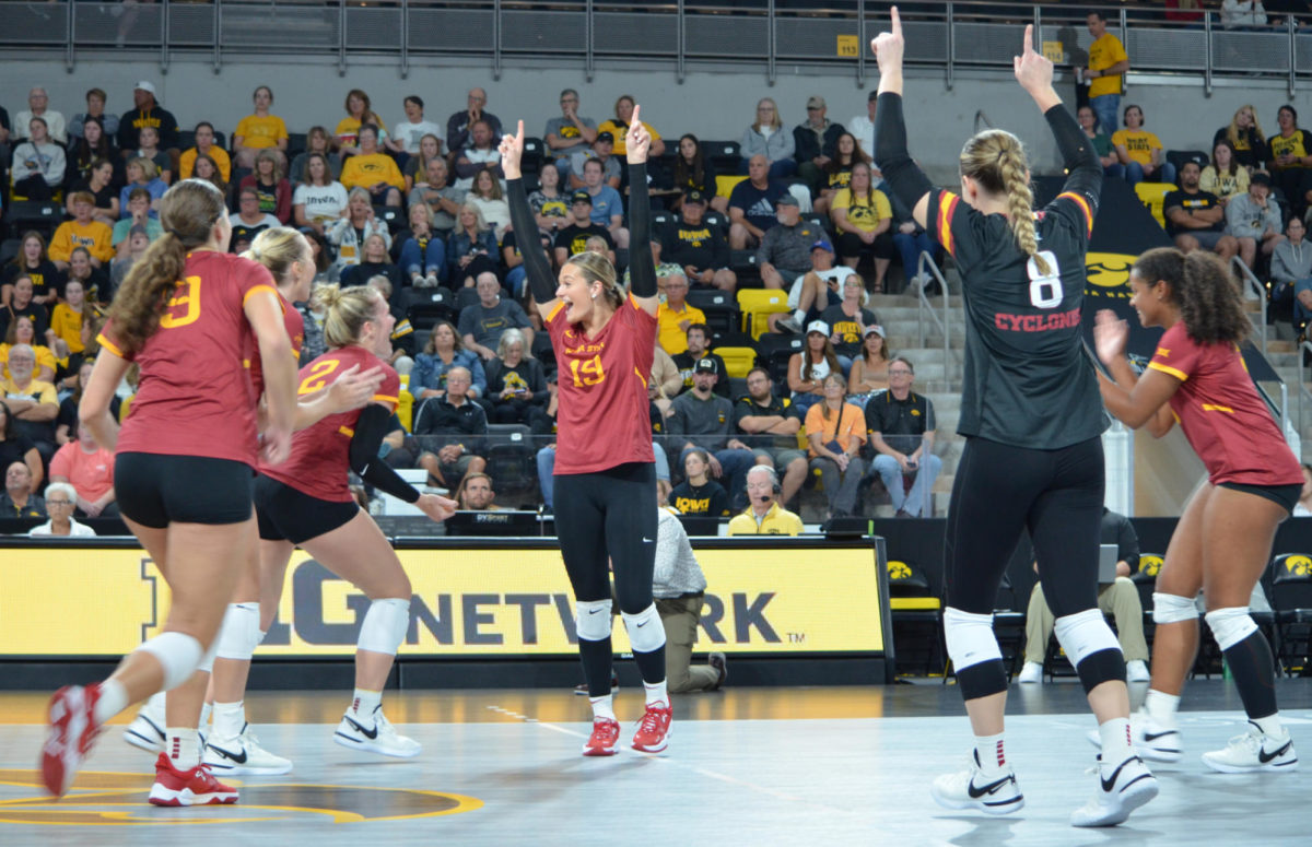 Iowa State University volleyball players celebrate after scoring a point against the University of Iowa during the game on Wednesday, Sept. 6, 2023.