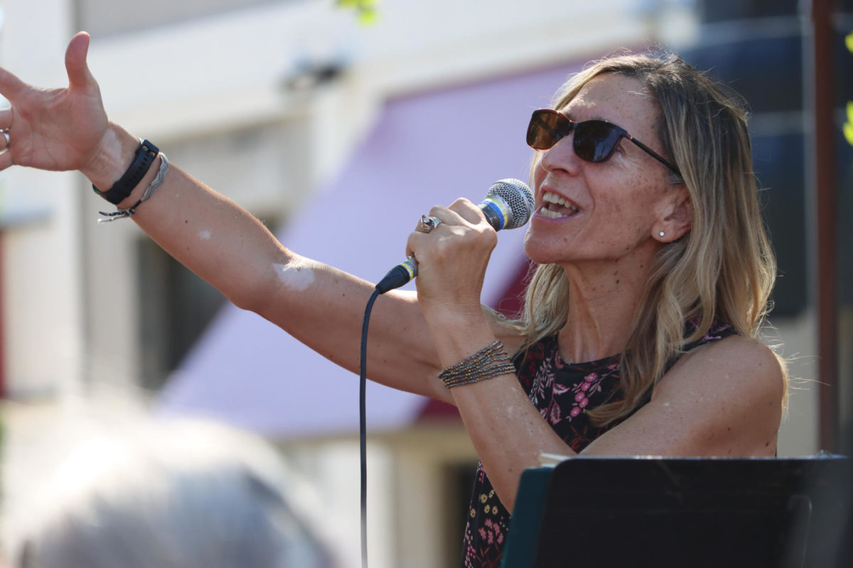 Lead singer of Kaiser Jazz, Lynn Kaizer, sings proudly for viewers at the Octagon Art Festival in Ames on Sunday, Sept. 24, 2023. 
