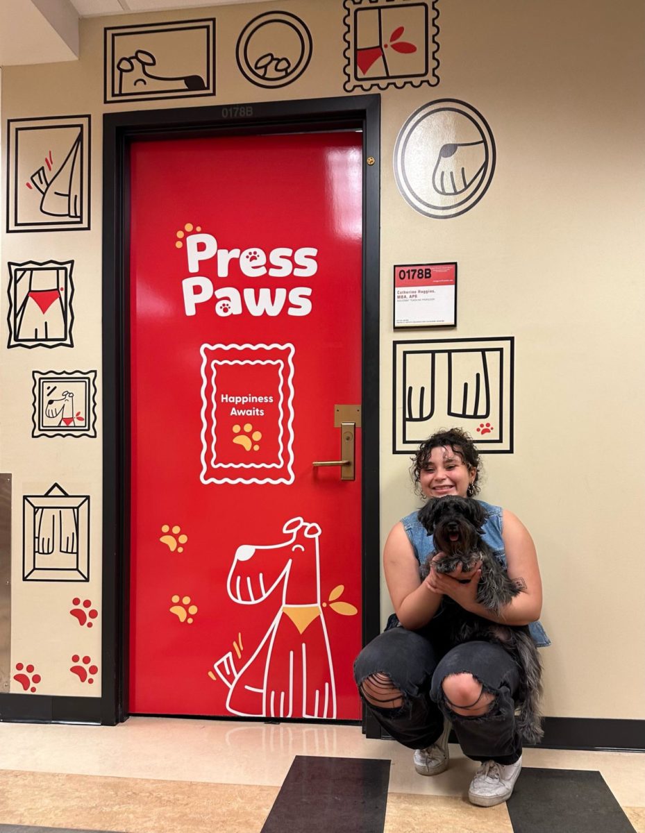 Adriana Rivera Rodríguez and her dog Lilo in front of the final Press Paws design installation.  