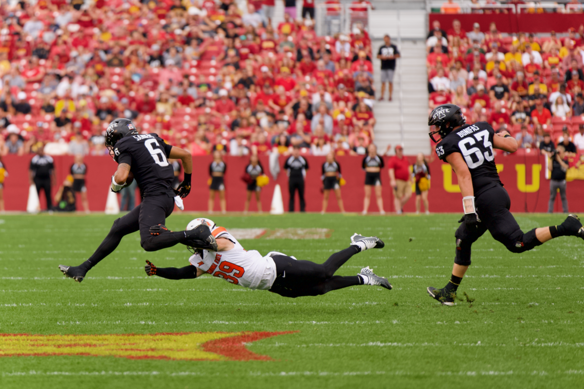 Parker Robertson of Oklahoma State attempting to tackle Eli Sanders of Iowa State in Jack Trice Stadium on Sept. 23, 2023.