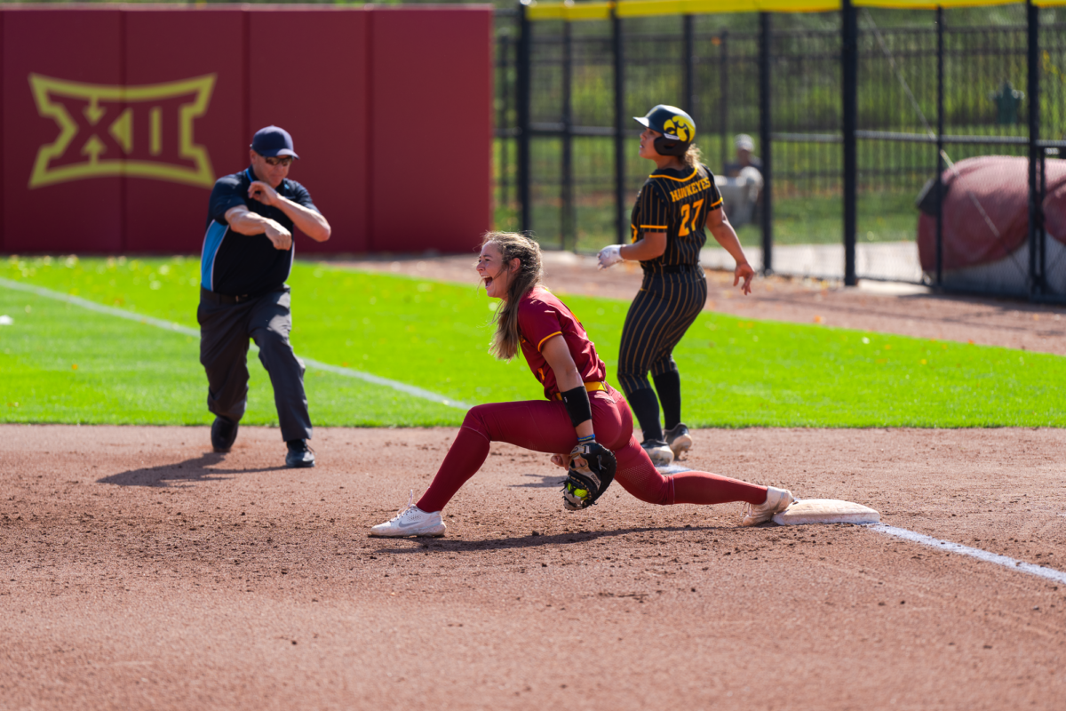 First baseman Carli Spelhaug cheering as tags out Amber DeSena of the Hawkeyes during the Iowa Vs. Iowa State match in the Cyclone Sports Complex on Sept. 30, 2023.