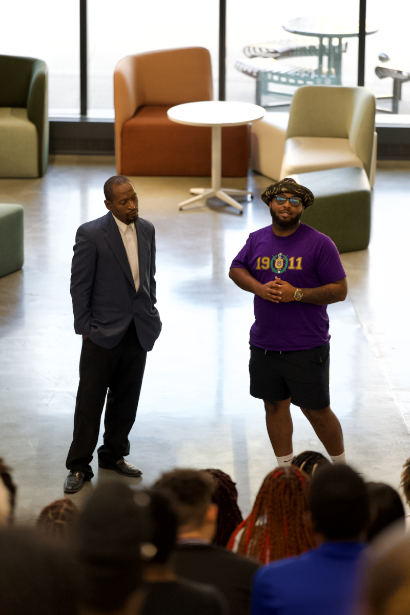 Omega Psi Phi members (insert name of left) and (insert name of right) presenting at the Nation Pan-Hellenic Council Meet the Greeks event in the Student Innovation Center on Sept. 14, 2023.