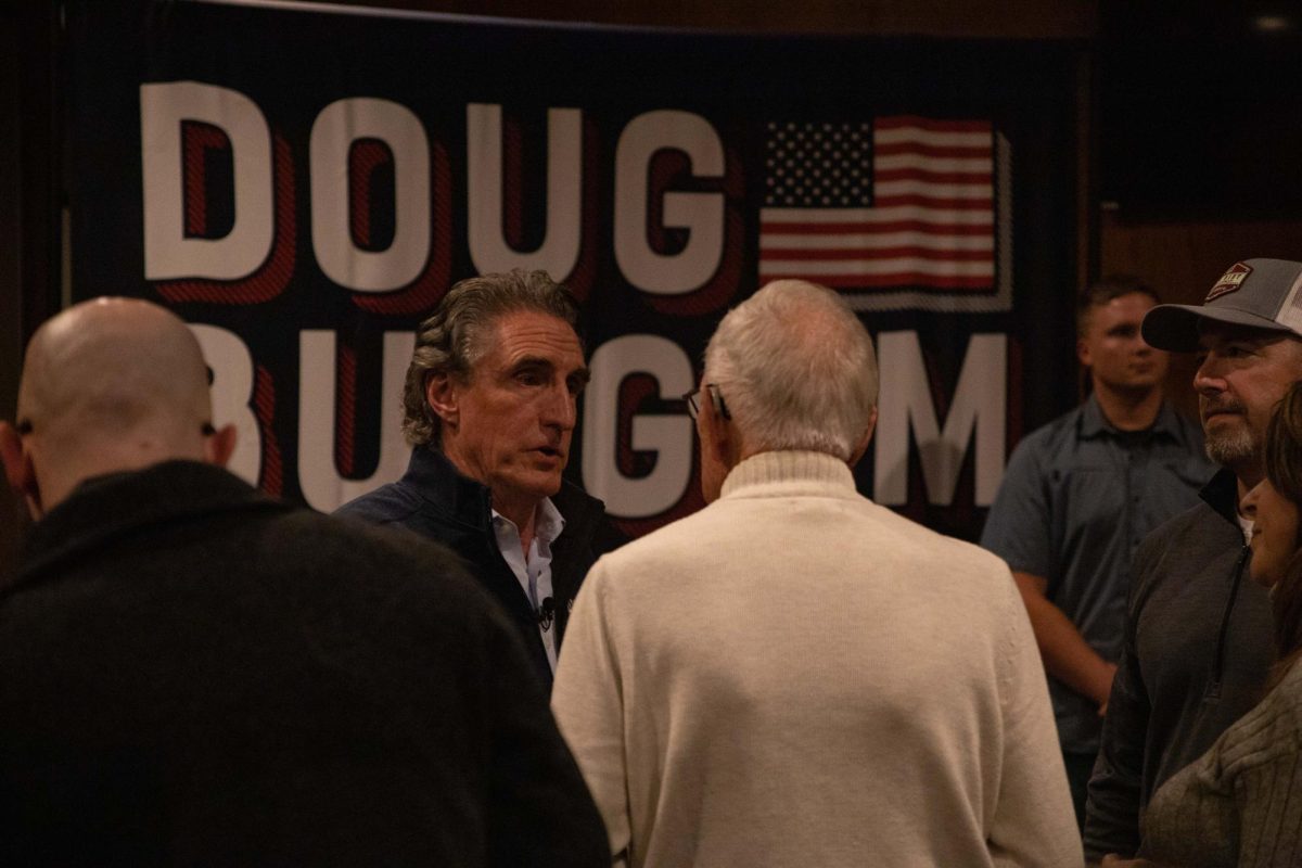 Doug Burgum talking to Lyle Dahl on October 19, 2023 at a Campaign stop at Jethros BBQ in Ames, Iowa.